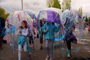 Image of girl in DIY Jelly fish costume made with clear umbrella and strips of colorful material